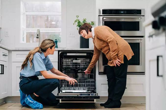 Technician explaining dishwasher repair to homeowner in North Myrtle Beach, SC