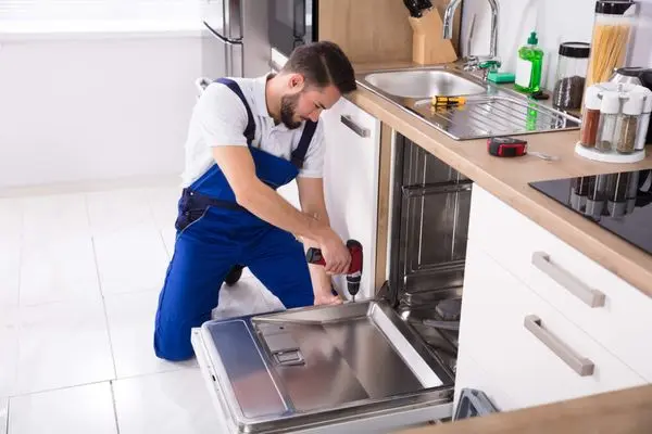 Appliance repair technician servicing a residential dishwasher in Surfside Beach, SC
