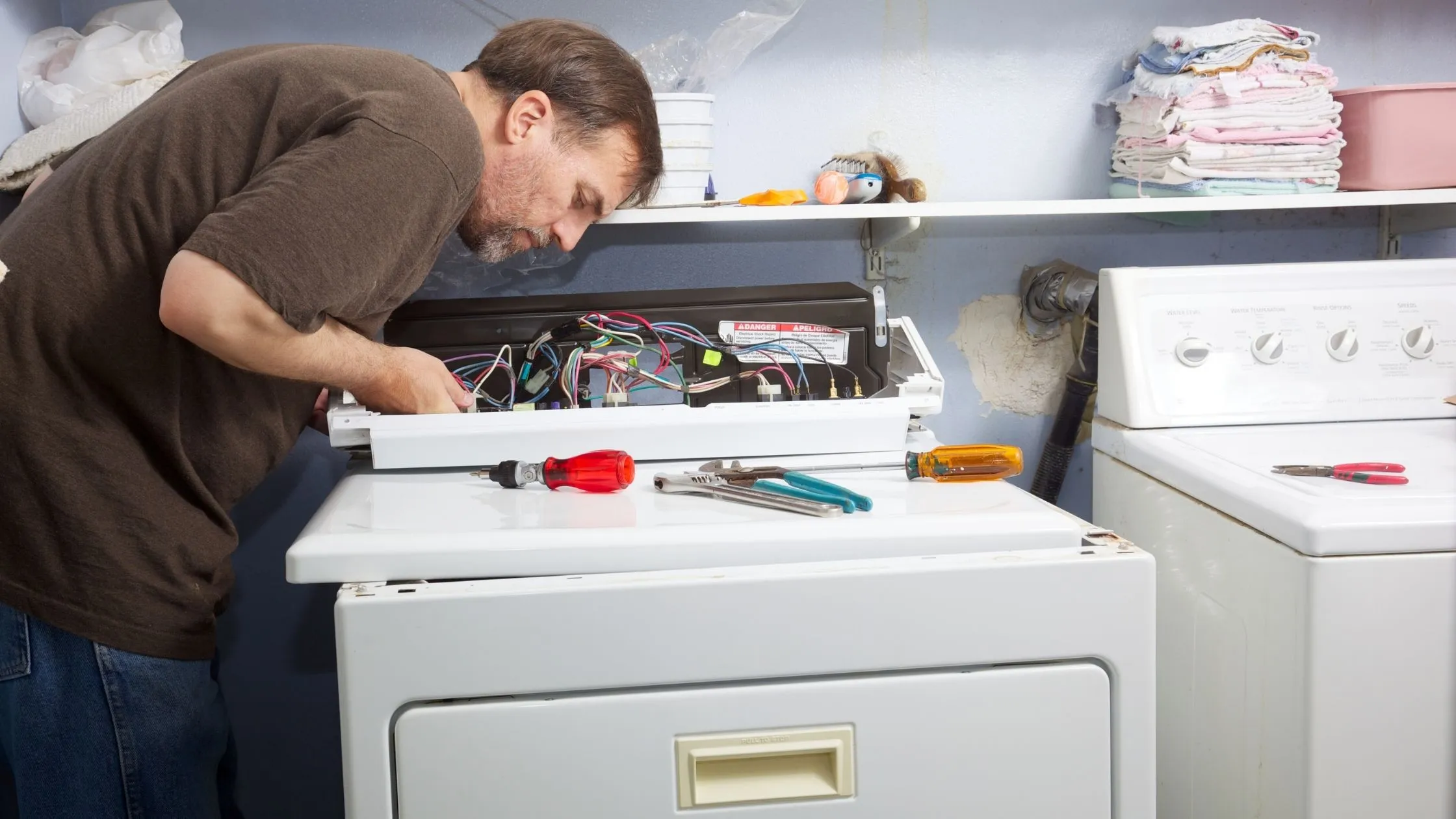 Appliance repair technician diagnosing and repairing an electric clothes dryer in Murrells Inlet, SC