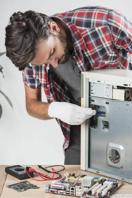 Appliance repair technician servicing a washing machine in a Carolina Forest, SC home