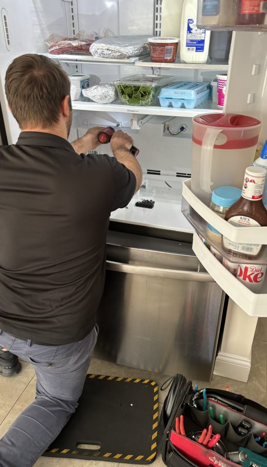 Myrtle Beach SC appliance repair technician servicing a home kitchen appliance
